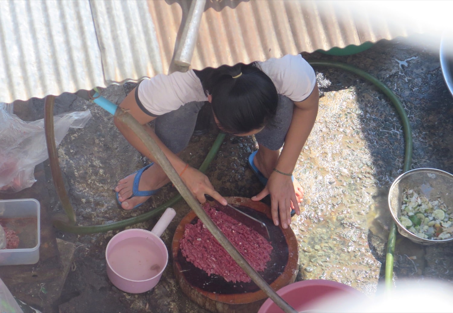 lady cutting meat laos naturebels