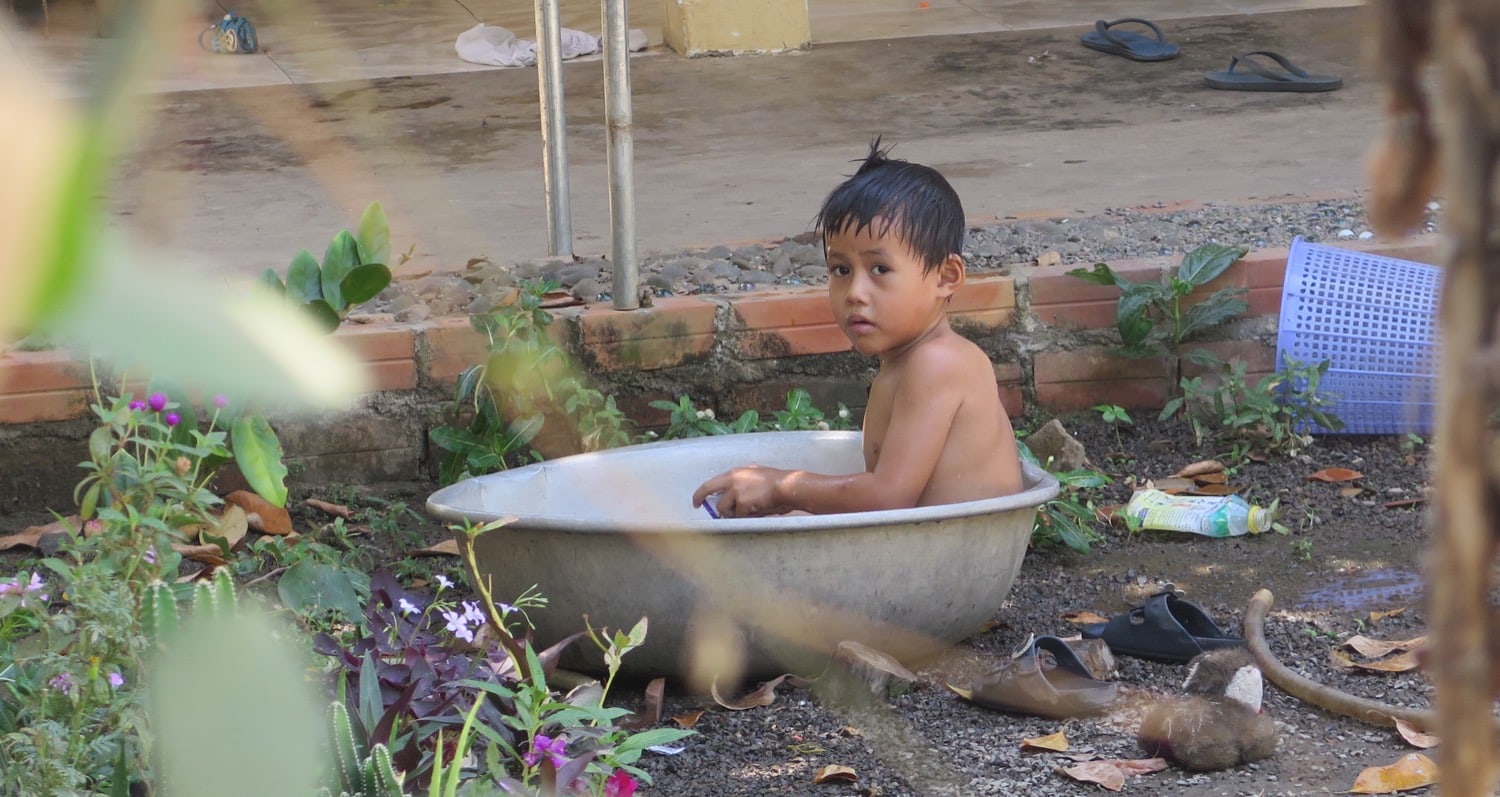 kid taking a bath battambang naturebels